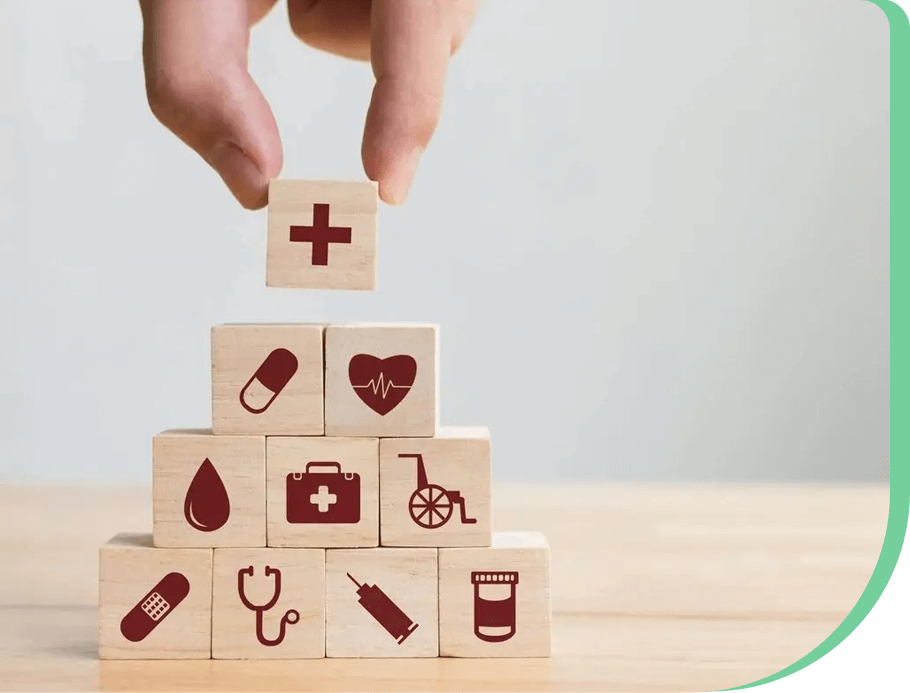 A hand is holding onto blocks with medical symbols on them.